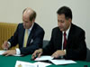 Mefford (left) and Minov (right) finalize the partnership agreement