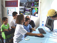 three boys eagerly waiting to see themselves in a lidar scan taken by Diane Minasian with the assistance of Brad Carkin