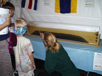 Li Erikson shows visitors how flowing water produces ripples and cross-beds