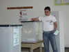 A voter casts his party and candidate ballots at a polling station in eastern Albania