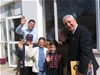 USAID/Romania Mission Director Rodger Garner (right) receives a warm reception from Father Gabriel Cazacu and Sfanta Macrina youngsters