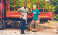 Partners Farmer to Farmer volunteer Norman Bezona and local coordinator Benito Jasmin transport bamboo plants in northern Haiti - Click to read this story