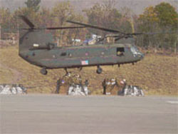 Carrying relief supplies, a U.S. military helicopter departs for earthquake-affected areas of Pakistan