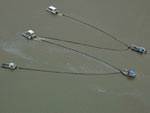 Image of tug boats pulling large booms in the Mississippi River