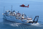 A U.S. Coast Guard helicopter hovers over the R/V Lake Guardian on Lake Michigan