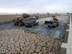 Loaders remove accumulaed silt from a section of 1 of 2 storage reservoirs in the Sweet Water Canal project that supplies all the fresh water to the city of Basrah and environs. The serpentine walls within the reservoir are designed to slow the flow of water allowing solids to settle  providing cleaner water to water treatment  plants downstream. The 275km canal, storage reservoir and pumping stations have suffered from a lack of maintenance and will be rehabilitated by USAID partner Bechtel at a cost of almost $12 milllion. When completed by March 1, 2004 it will serve 1.75 million citizens of the Basrah region.