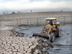 Loaders remove accumulaed silt from a section of 1 of 2 storage reservoirs in the Sweet Water Canal project that supplies all the fresh water to the city of Basrah and environs. The serpentine walls within the reservoir are designed to slow the flow of water allowing solids to settle  providing cleaner water to water treatment  plants downstream. The 275km canal, storage reservoir and pumping stations have suffered from a lack of maintenance and will be rehabilitated by USAID partner Bechtel at a cost of almost $12 milllion. When completed by March 1, 2004 it will serve 1.75 million citizens of the Basrah region.