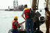 Great Lakes Dredge and Dock Co. employees wait for the Colorado River vessel at Umm Qasr (Photo: Courtesy of Bechtel National, Inc.)