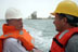 Cliff Mumm, Bechtel program director for the Iraq reconstruction project (left), with Roy Woods, Great Lakes Dredge and Dock project manager for dredging operations at Umm Qasr. Port of Umm Qasr in the background. May 8, 2003. (Photo by Jonathan Elliman for Bechtel)