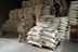 Workers store food supplies in a World Food Program warehouse in Umm Qasr, southern Iraq. USAID supports the program which provides basic food rations to a large number of needy families in Southern Iraq.