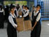 Students from the Hala Bint Khuwaylid secondary girl's school in the Amil district of Baghdad carry boxes of new school bags which contains, pens, pencils, notebooks, a calculator and other school supplies. USAID is funding the purchase and distribution of 1.5 million of the bags through a contract with Creative Associates International. All Iraqi secondary students will receive the bags.