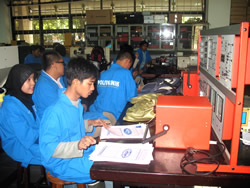 photo, students using electronis equipment while receiving training.  