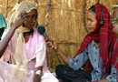 Photo: A reporter interviews a refugee woman in the Gaga Refugee Camp.