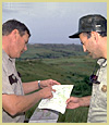 [Photograph]: Forest Service employees reviewing paperwork.