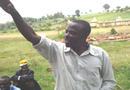 Photo: An internally displaced man from the Rukuini IDP camp addresses local councilors. The gutted building the background is a vivid reminder of the post-election violence.