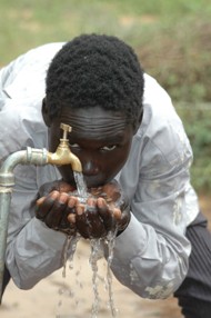 A Sudanese boy enjoys access to safe drinking water provided with USAID funds.