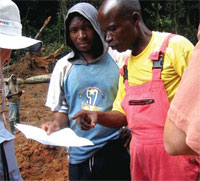 Photo of Congolese foresters review management plans for reduced impact logging practices in the
                      northern Republic of Congo, where USAID is studying the impacts on carbon stocks.