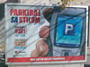 A public billboard advertising Indjija's new pay-by-phone parking system