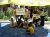 Anar (in wheelchair) participates in a role play activity at the opening ceremony for the USAID-supported Children and Family Support Center in Mingechevir.