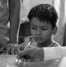 Photo: A young TB patient and his mother at a health clinic in East Delhi.