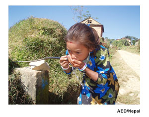 A Nepali girl drinks from a water tap. Photo Source: AED/Nepal