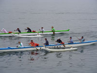 Team Pohaku Mana in the blue-and-white outrigger narrowly pulls ahead of another competitor