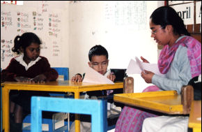 Image of a female Indian teacher, working with children 