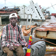 Worker at severely damaged and largely idle port in Liberia.