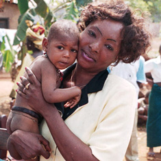 Health worker and infant in Guinea