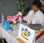 A physician in her private clinic with some educational materials from a local NGO that encourages youth to use health care facilities