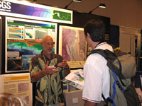 Mike Torresan talks to a conference attendee visiting the U.S. Geological Survey booth.