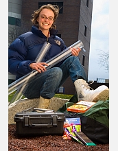 Female geologist with gear she uses for lake sediment coring.