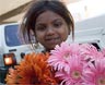 A child sells flowers on the street. Kay Chernush for the U.S. State Department.