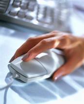 Photograph of a hand on a computer mouse.
