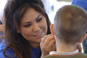 SCF Volunteer paints child's face at employee picnic.