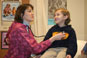 Nurse checking vitals on young boy.