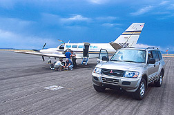 Photo: Loading equipment on a twin-engine Cessna 404 Titan for a flight over the Jornada Range. Link to photo information