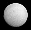 Ithaca Chasma rips across Tethys from north to south near the center of this view. The moon's western limb is flattened, indicating the rim of the giant impact basin Odysseus