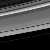 The Cassini spacecraft looks toward the unilluminated side of Saturn's rings to spy on the moon Pan as it cruises through the Encke Gap