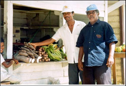 Photo: Men examine produce for sale.