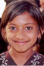 Little girl smiling. Photo Credit: Kristen Kelleher, USAID India