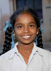 Smiling girl. Photo Credit: Sunil Lucas, CRS