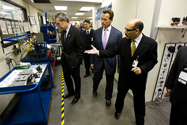 Secretary of Commerce Carlos M. Gutierrez and California Governor Arnold Schwarzenegger join officials of Hitachi Automotive Products USA Inc.