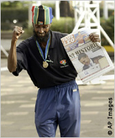 Man holds newspaper (AP Images)