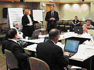 Experts from the scientific community convene around a conference table to evaluate grant applications