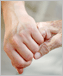 photo of a young hand holding an elderly hand.