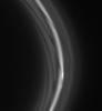 The striated appearance of the F ring is immediately apparent in the region of the ring that trails behind the moon Prometheus