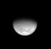 From high above Titan's northern hemisphere, the Cassini spacecraft takes an oblique view toward the mid-latitude dark regions that gird the giant moon