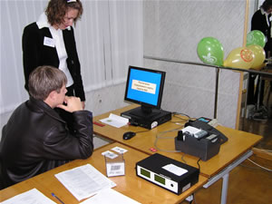 Golos-trained observers watch an electronic voting computer tally votes at a polling station in Novgorod