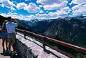 A man and a women at a scenic vista looking down into a valley.